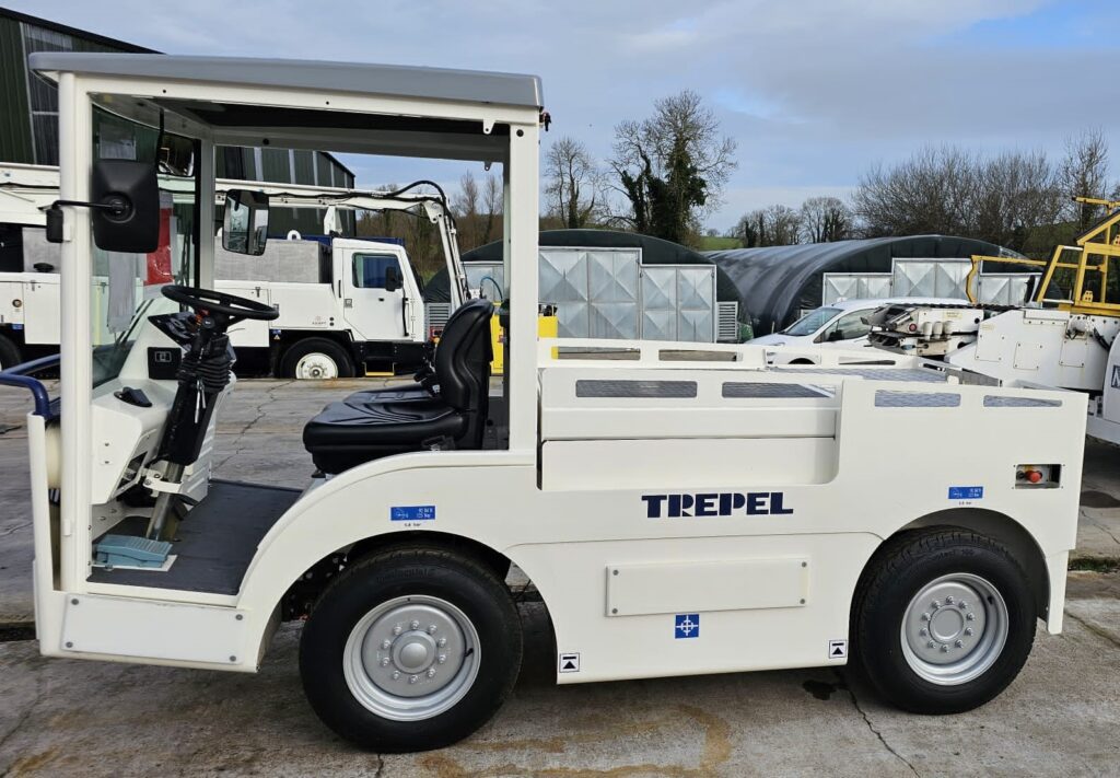 Side view of a white Trepel ground support vehicle parked on a concrete surface